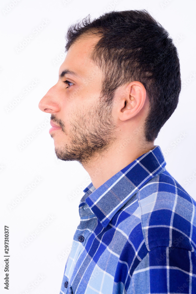 Closeup profile view of young bearded Persian hipster man Closeup profile view of young bearded Persian hipster man