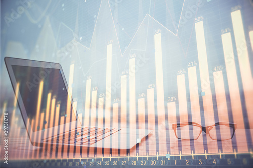 Forex graph hologram on table with computer background. Multi exposure. Concept of financial markets.