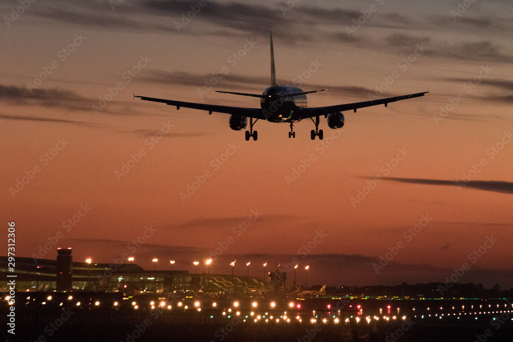 Airplane silhouette landing at the airport during sunser, Barcelona Airplane silhouette landing at the airport during sunser, Barcelona