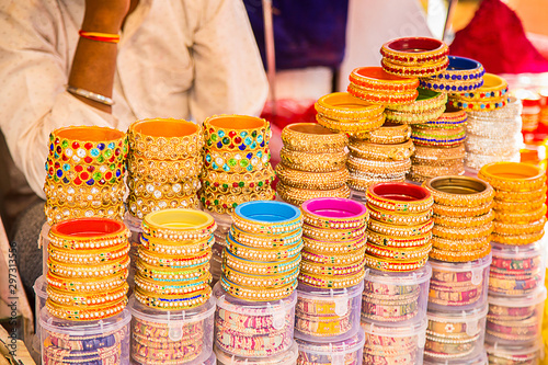 Indian colorful bracelets and golden bangles or armbands displayed in local shop in a market of pushkar, Rajasthan, India