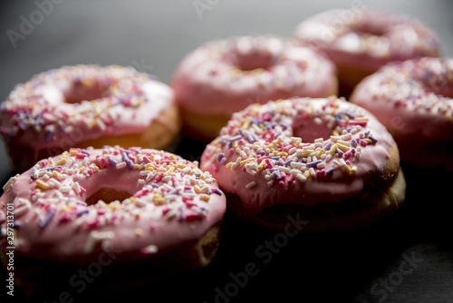 Closeup shot of pink donuts with sparkles with a blurred background photo