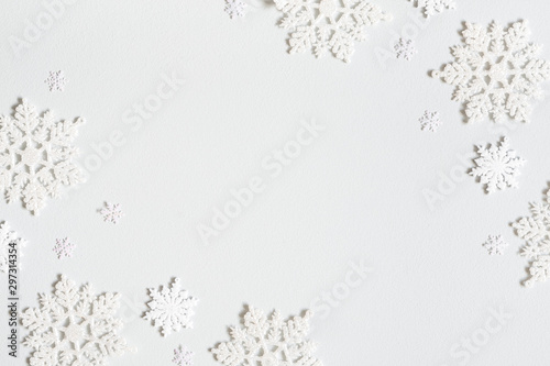 Fototapeta Naklejka Na Ścianę i Meble -  Christmas composition. Frame made of snowflakes on pastel gray background. Christmas, winter, new year concept. Flat lay, top view, copy space