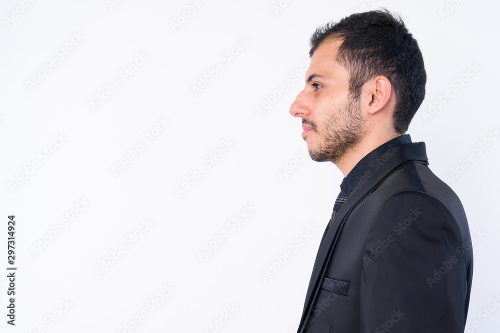 Closeup profile view of young bearded Persian businessman in suit Closeup profile view of young bearded Persian businessman in suit