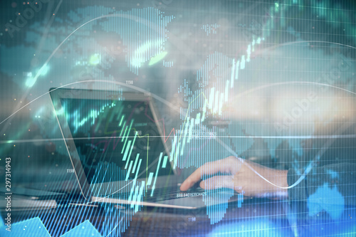 Double exposure of businessman with laptop and stock market forex chart.