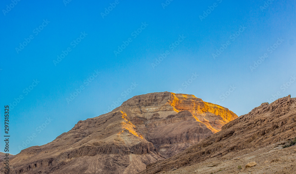morning sun rise lighting falling on Eastern desert sand stone rocks peaceful picturesque natural scenic view 