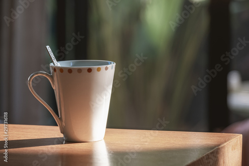 White Cup on Wooden Table in Home.