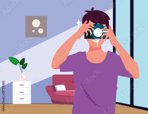 man with photographic camera in the living room