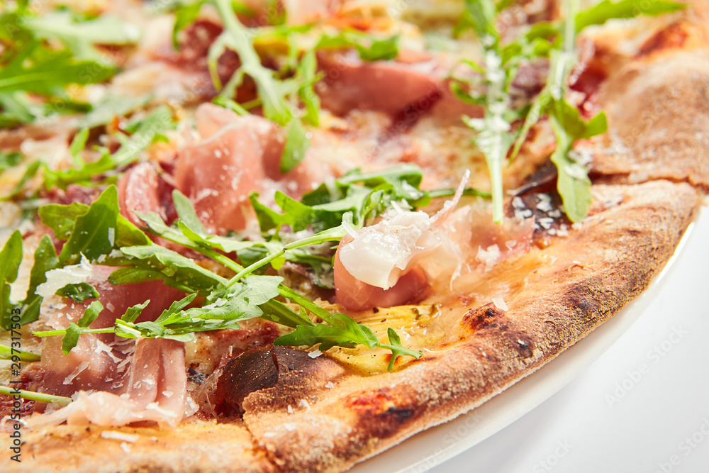 Tasty parma ham and artichoke pizza closeup Tasty parma ham and artichoke pizza closeup