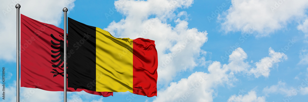 Albania and Belgium flag waving in the wind against white cloudy blue sky together. Diplomacy concept, international relations. Albania and Belgium flag waving in the wind against white cloudy blue sky together. Diplomacy concept, international relations.