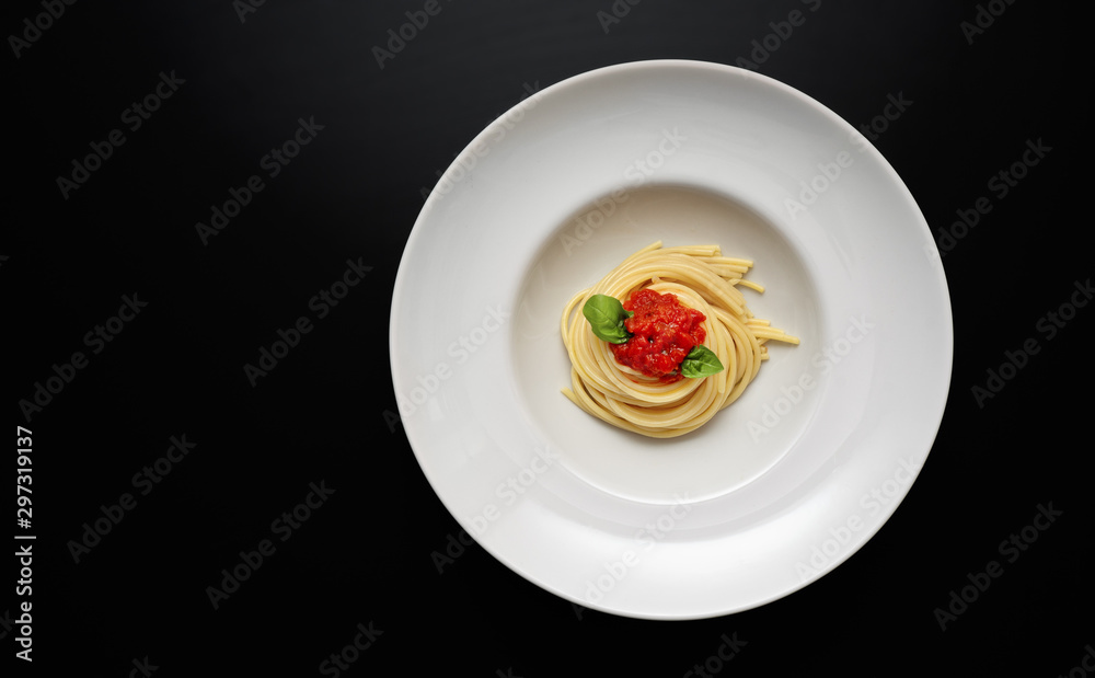 Top view of white plate with spaghetti on modern background Top view of white plate with spaghetti on modern background