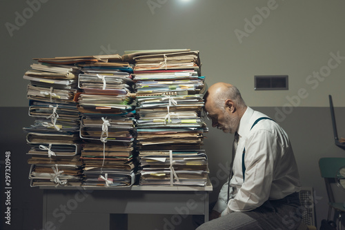Desperate business executive with lots of paperwork photo