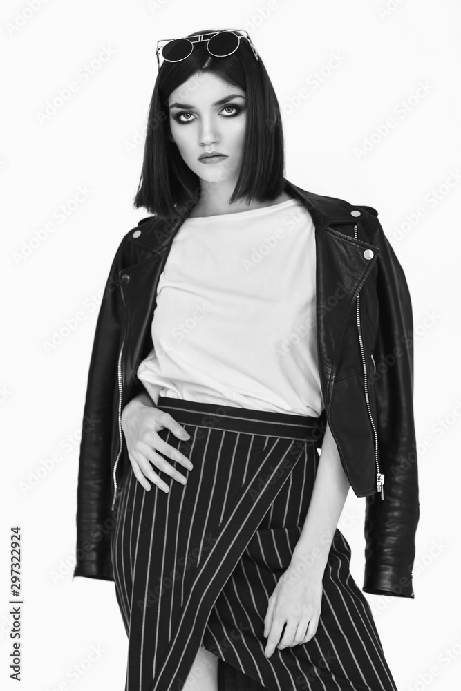 Fashion portrait of a young woman in leather jacket. Black and white ...