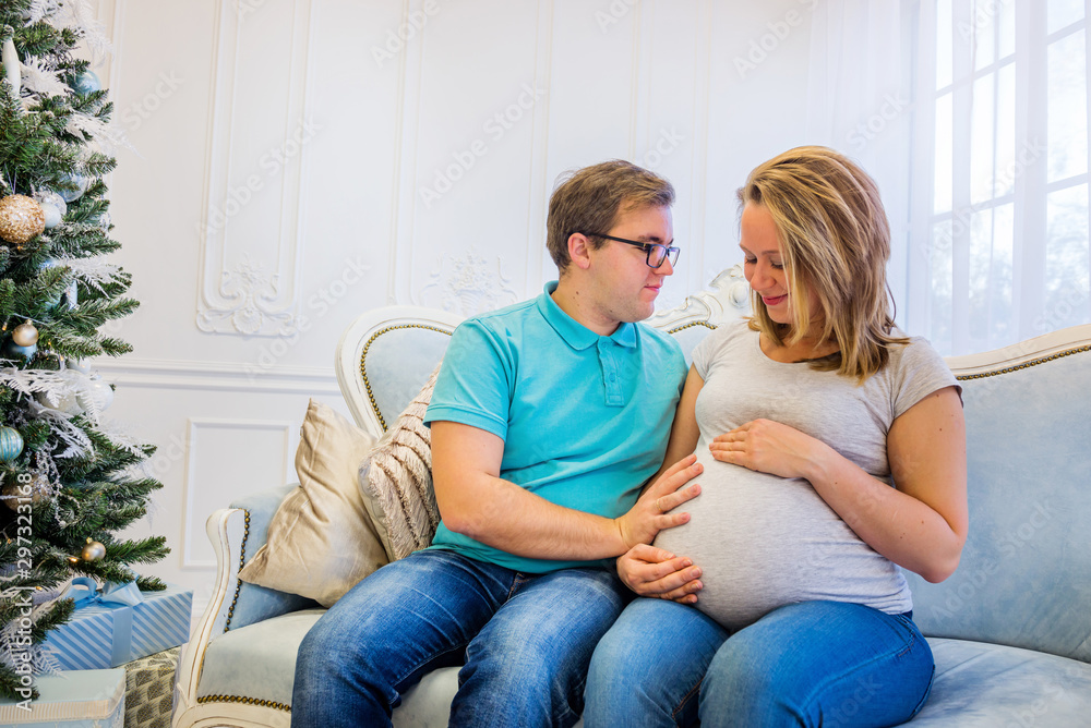 Family portrait near christmas tree. Pregnant woman. Family portrait near christmas tree. Pregnant woman.
