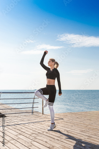 Woman in sportswear doing a high jump.