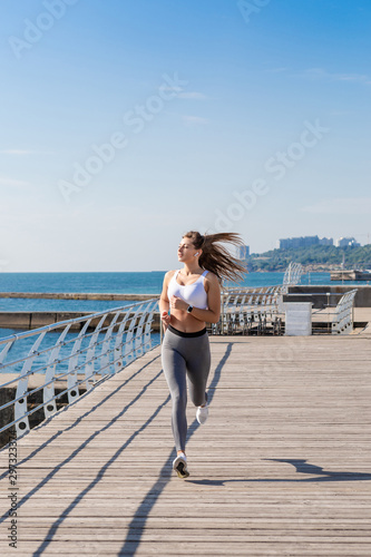 Running woman with long brunette hair.