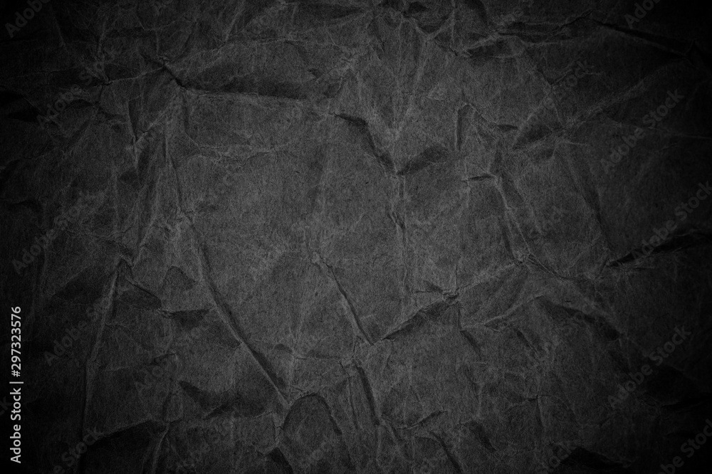 Fototapeta premium Black crumpled packaging paper background texture. Dark Kraft Paper Coarse. Wrinkled paper bag
