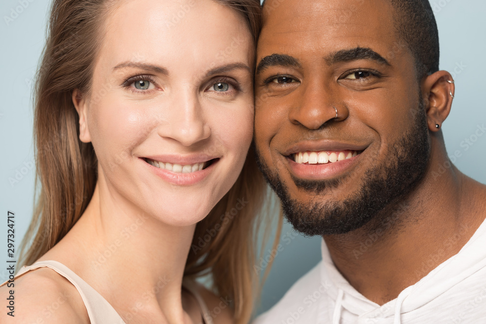 Portrait of smiling multiracial couple look at camera cuddling Portrait of smiling multiracial couple look at camera cuddling