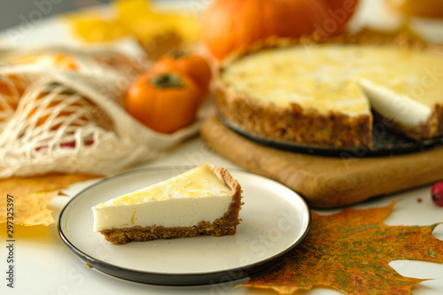 pumpkin cheesecake with persimmon. autumn concept.