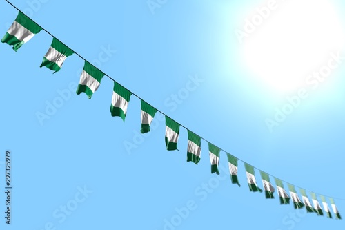 pretty many Nigeria flags or banners hangs diagonal on rope on blue sky background with soft focus - any celebration flag 3d illustration..