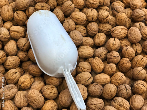 Walnuts in box with plastic bailer close-up on market