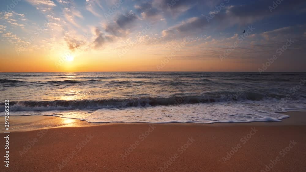 Sea sunrise, splashing waves and sandy beach Sea sunrise, splashing waves and sandy beach