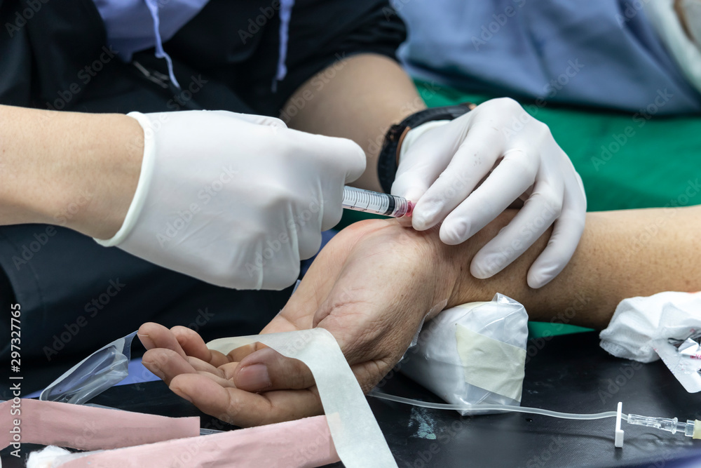 Fototapeta premium Nurse taking blood sample from patient in the operating room. blood drawing sample for blood test the health.