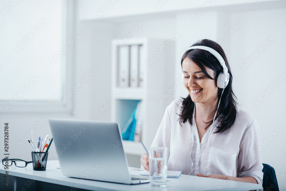 Woman with headphones at the workplace Woman with headphones at the workplace
