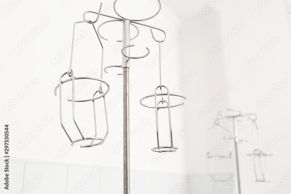 metal stand for droppers, intravenous infusions. White background, hospital interior