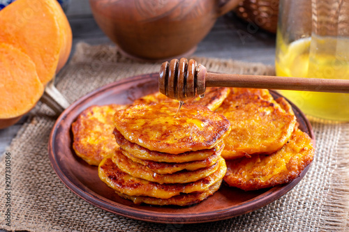 Pumpkin pancakes with honey on a plate