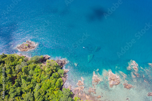 Aerial top view of ocean waves, beach and rocky coastline and beautiful forest. Beautiful nature background. island background and tropical with tourist
