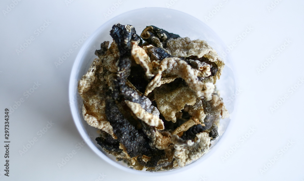 Fish skin crackers on white background. Made from patin fish. Fish skin crackers on white background. Made from patin fish.