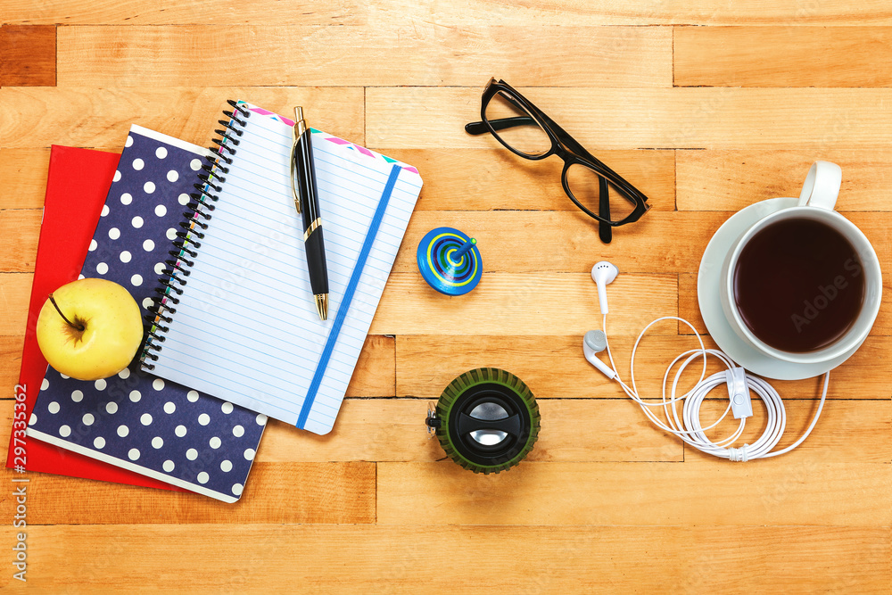 Notebooks, pen, glasses, apple on a wooden. Notebooks, pen, glasses, apple on a wooden.