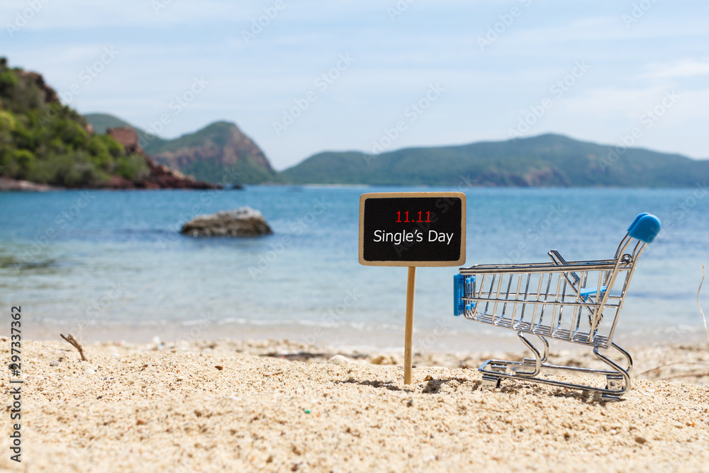 Online shopping of China, 11.11 single's day sale concept. The shopping cart and the text 11.11 single's day sale on the beach. Online shopping of China, 11.11 single's day sale concept. The shopping cart and the text 11.11 single's day sale on the beach.