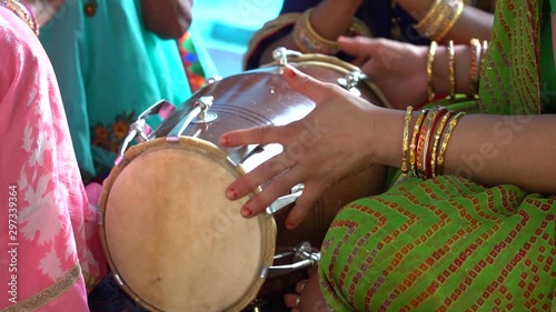 Indian Female Playing Rhythm on Dholak Hand Drum, Close Up Slow Motion photo