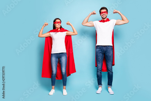Full length body size view of nice attractive competitive cheerful sporty people wearing red hero look demonstrating arm muscles isolated on bright vivid shine vibrant blue turquoise background