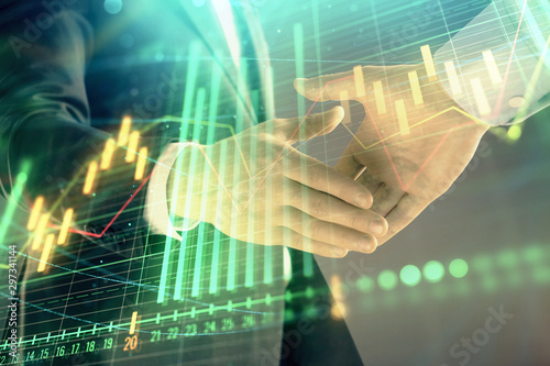 Wallpaper Mural Multi exposure of forex graph on abstract background with two businessmen handshake. Concept of success on stock market Torontodigital.ca