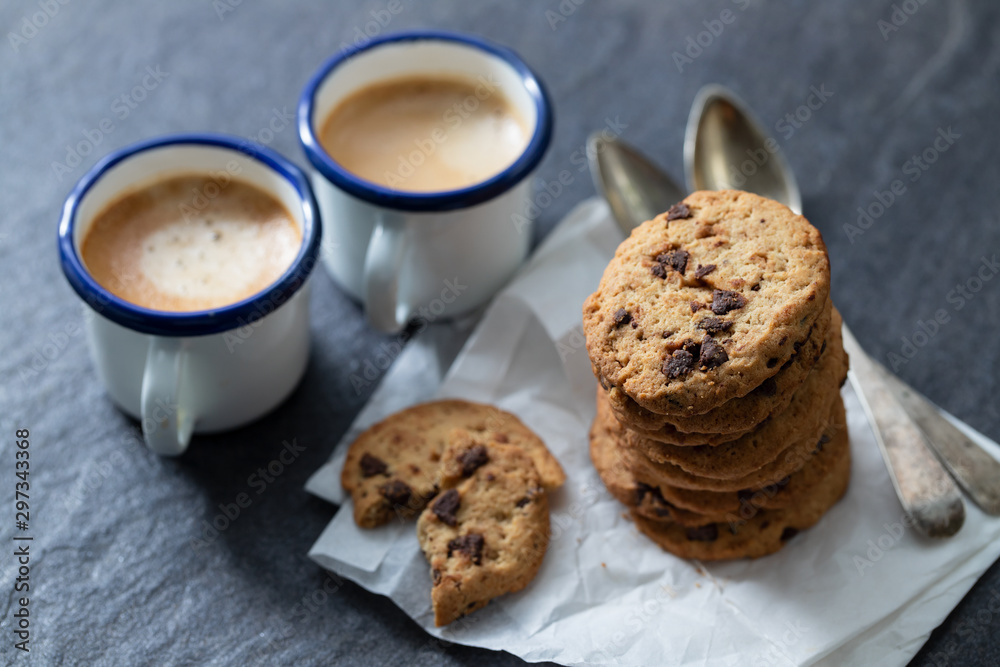coffee and cookies with chocolate chips on ceramic background coffee and cookies with chocolate chips on ceramic background