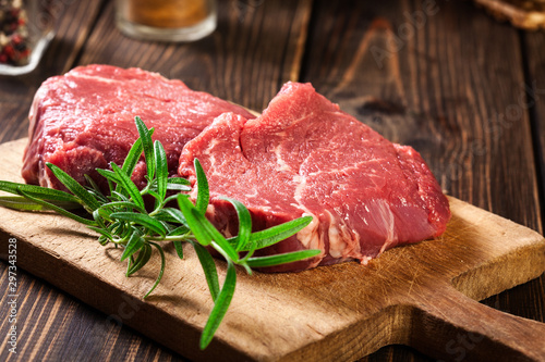 Fresh raw beef steak sirloin with rosemary photo