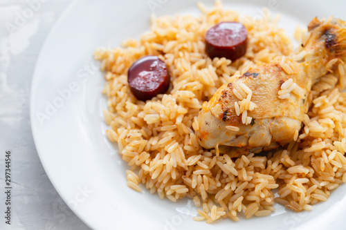 chicken with smoked sausage and rice on white plate