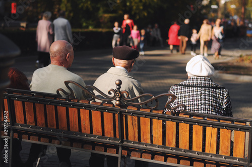 A senior  sitting on a bench