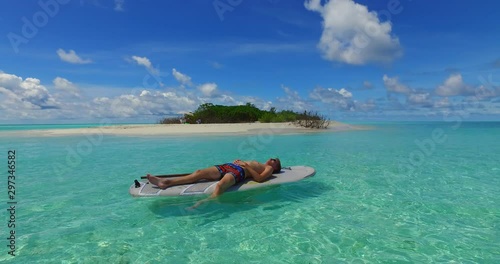 Adult man relacing on the surfboard photo