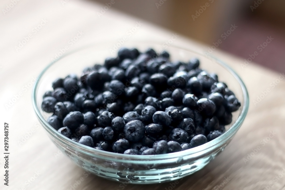 Bowl of blueberries on wooden table. Selective focus. Bowl of blueberries on wooden table. Selective focus.