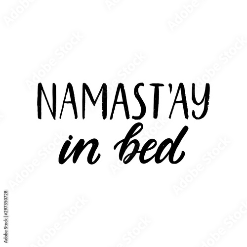 Namastay in bed. Hand written lettering quote. Cozy phrase for winter time. Modern calligraphy poster. Inspirational fall sign. Black and white.