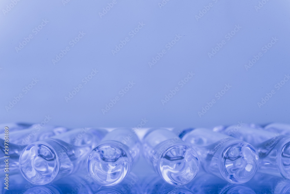 Glass medical ampoule vial for injection. Medicine is liquid sodium chloride with of aqueous solution in ampulla. Close up. Bottles ampule multicolor. Glass medical ampoule vial for injection. Medicine is liquid sodium chloride with of aqueous solution in ampulla. Close up. Bottles ampule multicolor.