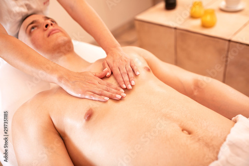 Attractive young man in a beauty massage salon
