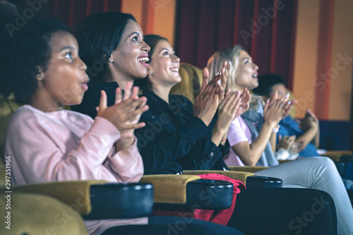 People applauding in the movie theater.