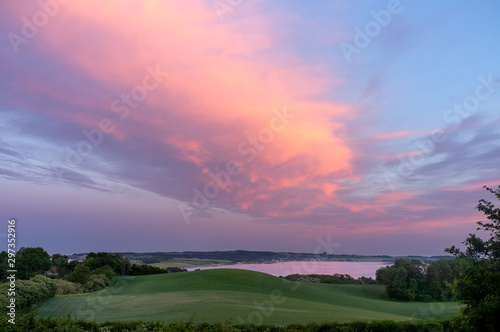 View on Helgenæs in Denmark at sunset with pink clouds and sky