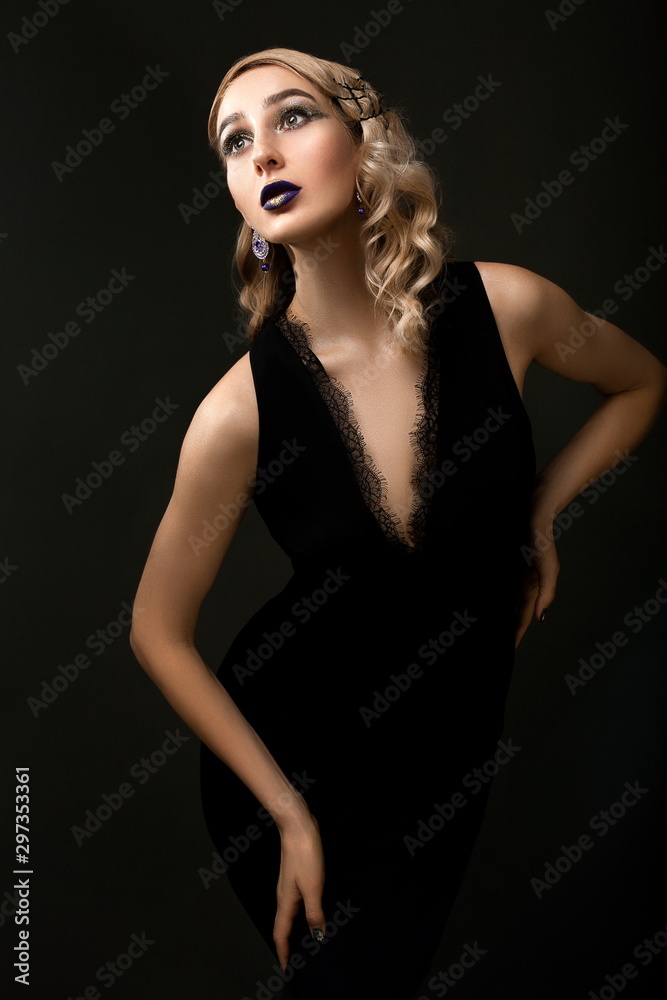 Beautiful girl with retro hairstyle and bright lilac makeup with golden glitters posing on dark background. copy space Beautiful girl with retro hairstyle and bright lilac makeup with golden glitters posing on dark background. copy space