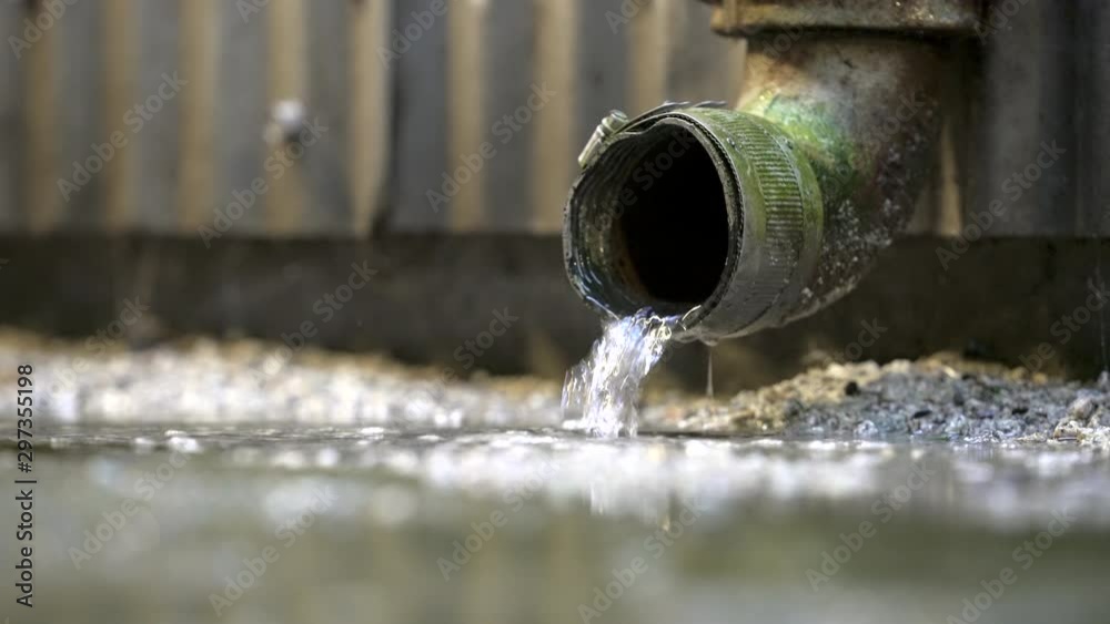 Rainwater Pouring out of a Downspout 4K UHD. Rainwater coming out of a downspout on the side of a building during heavy rain. 4K UHD. Rainwater Pouring out of a Downspout 4K UHD. Rainwater coming out of a downspout on the side of a building during heavy rain. 4K UHD.