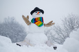 Cute little snowman outdoor. Winter time scene. Christmas background with snowman. The morning before Christmas.